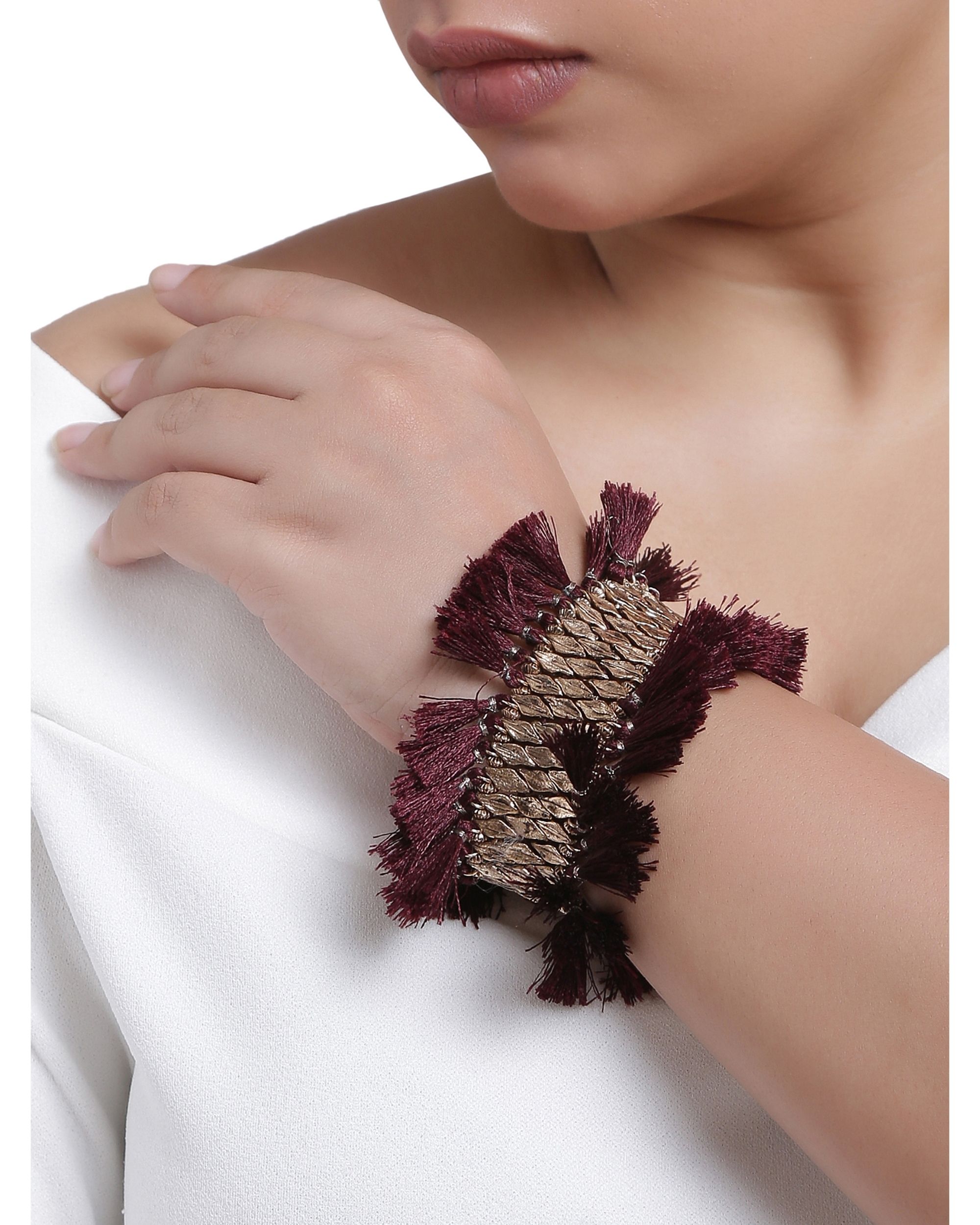 Beads and burgundy tasseled bracelet
