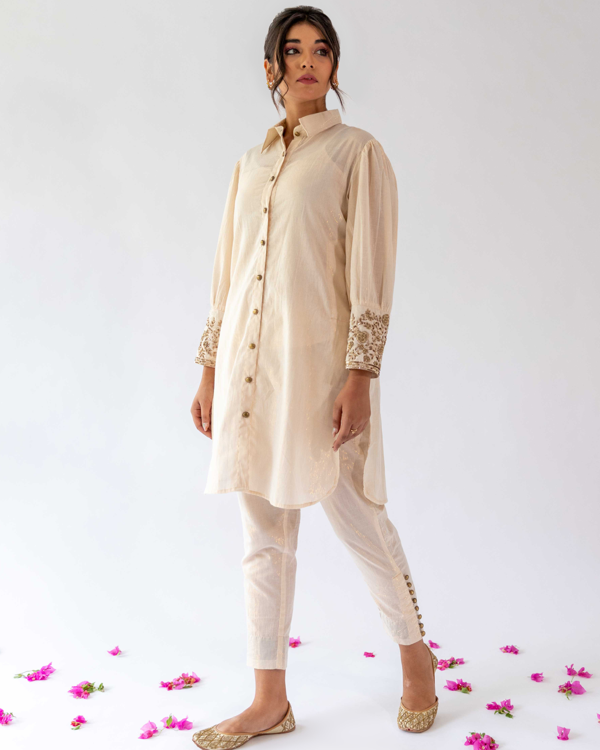 Ivory tappered pants with buttons detailing