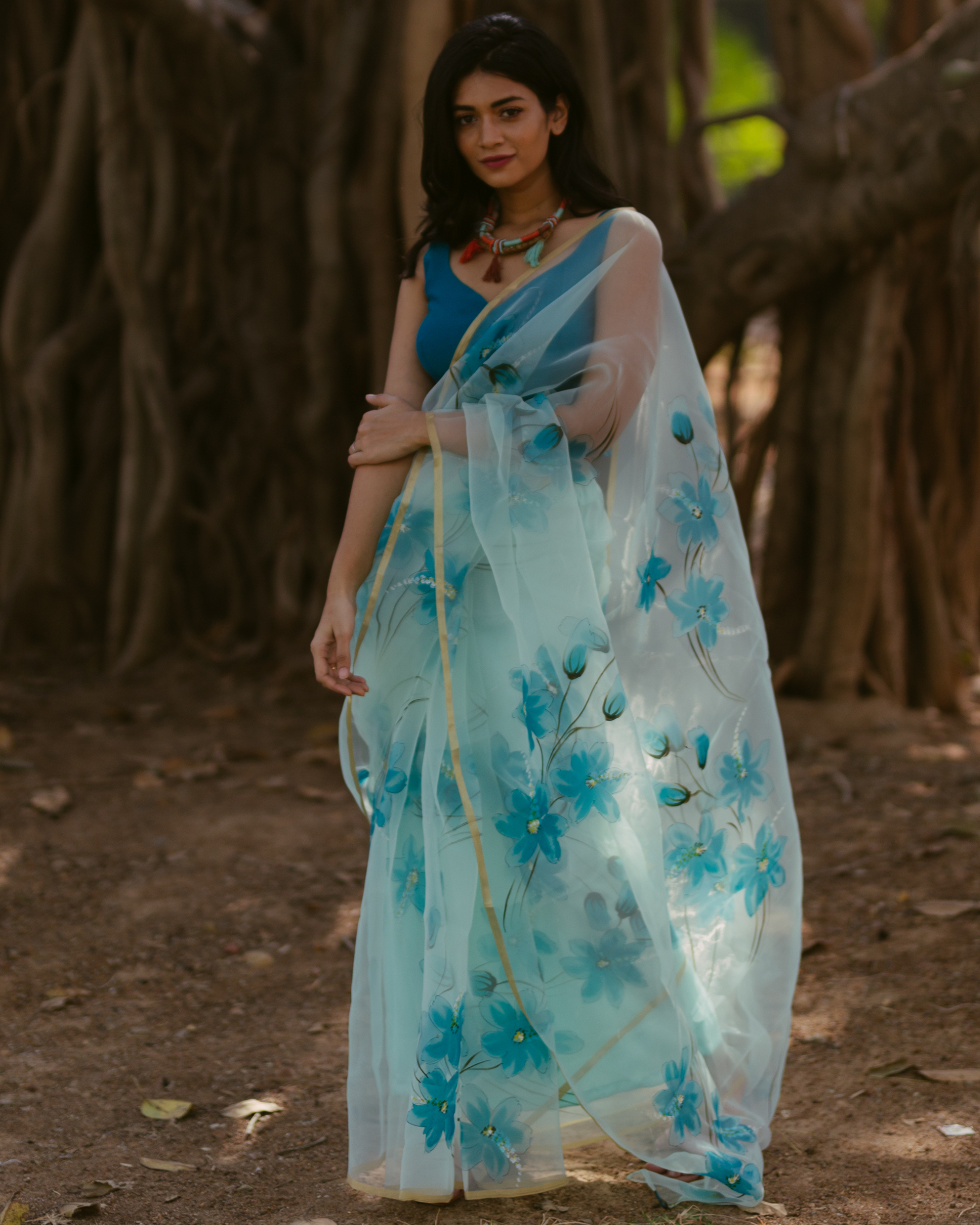 Turquoise floral hand painted organza saree