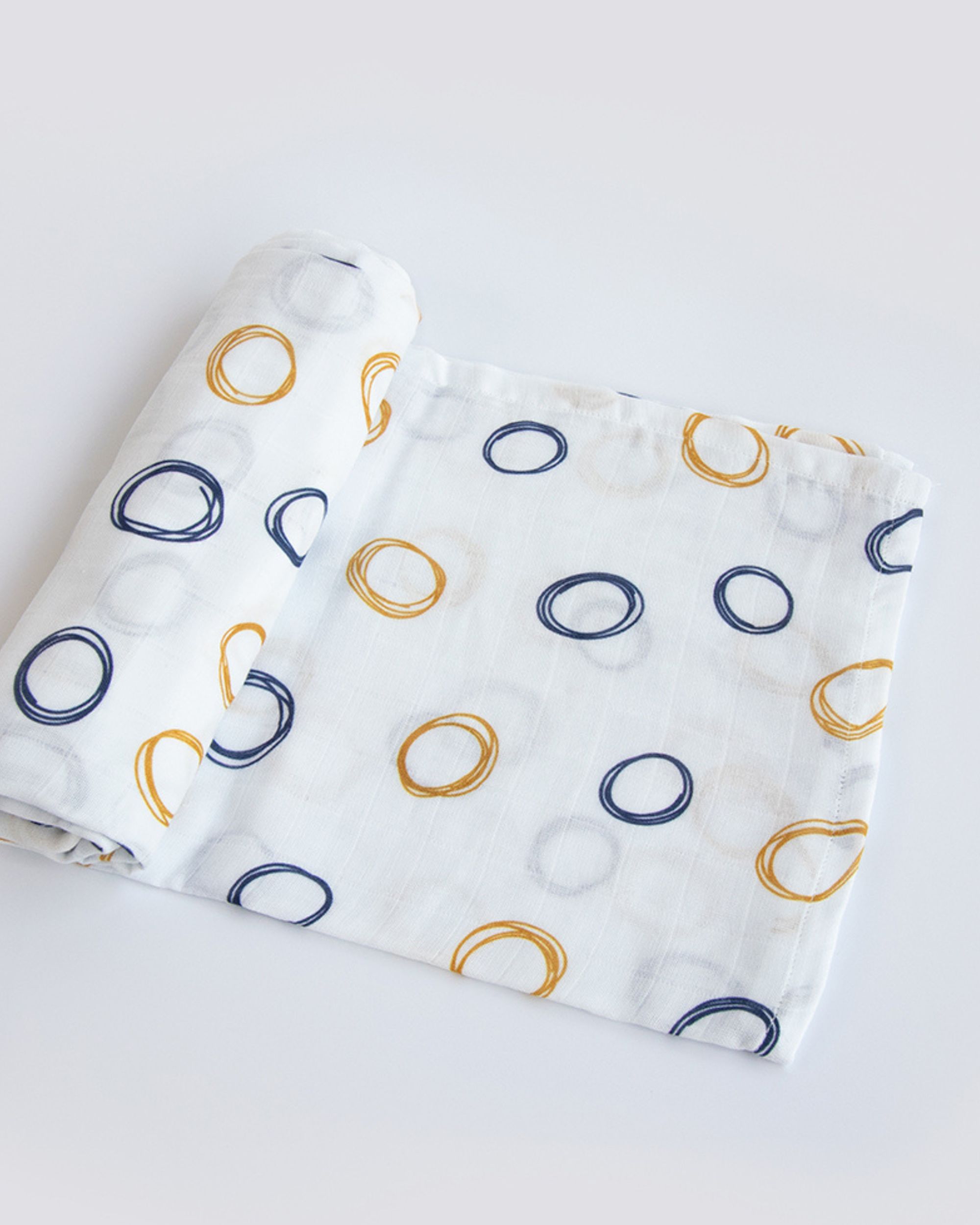Blue and yellow doodled muslin swaddle