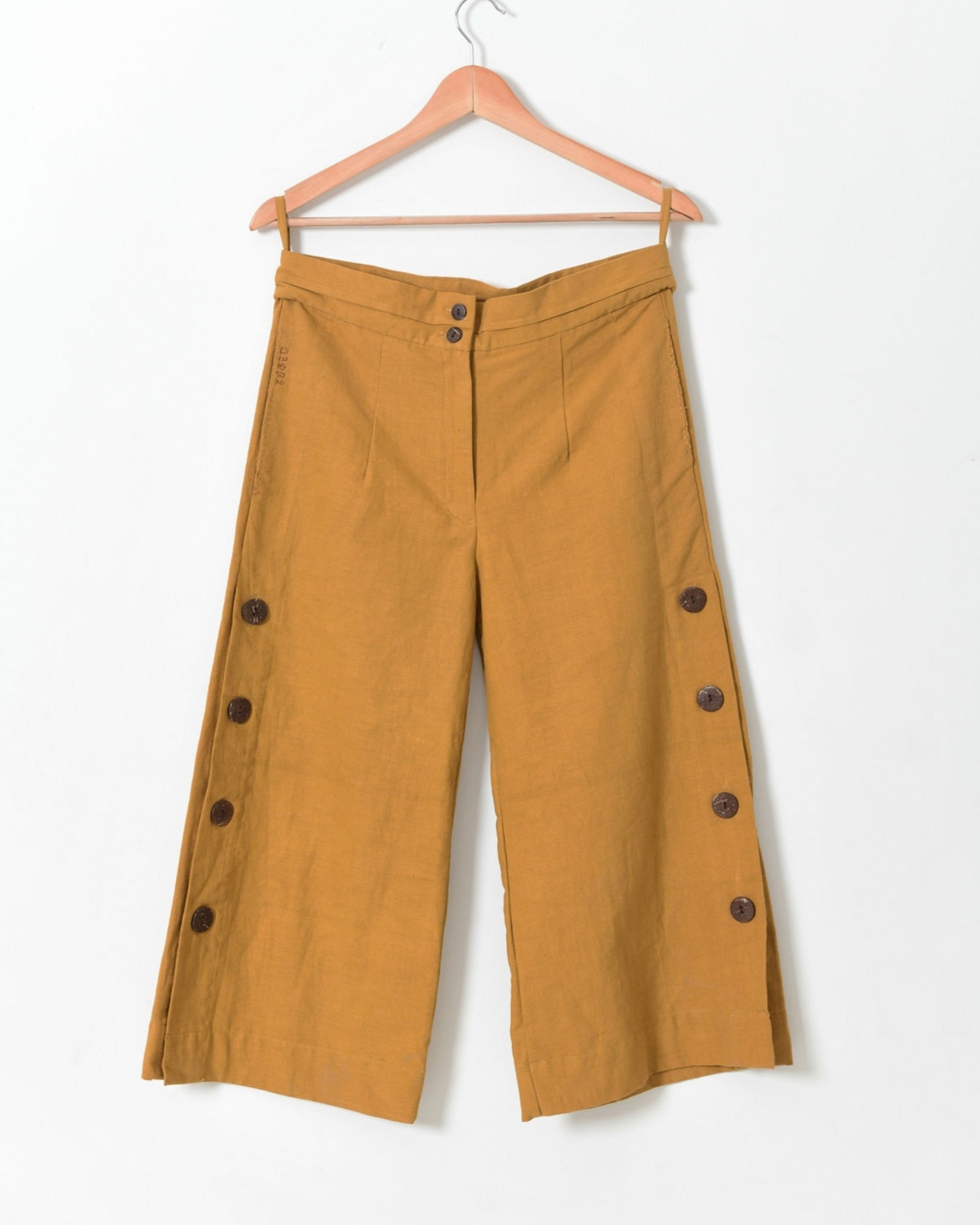 Pale mustard side open pants with buttons detailing by Rias | The ...
