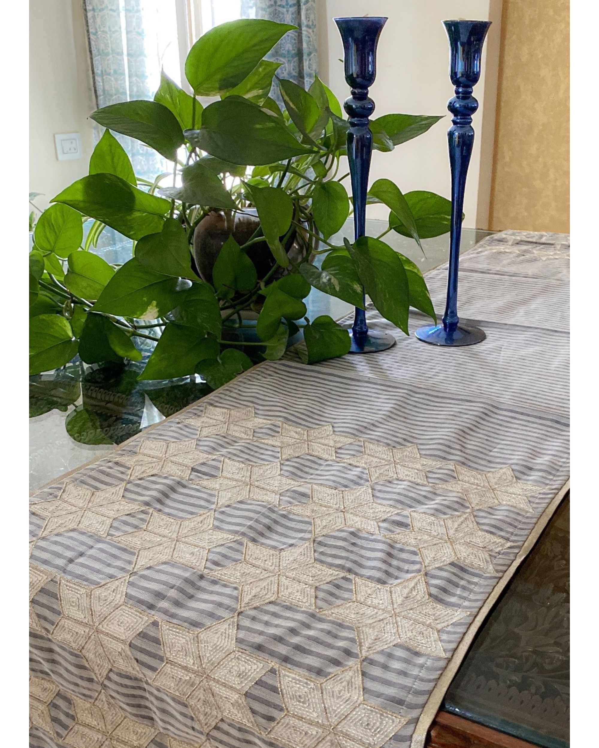 Light grey and white geometric embroidered table runner by Taramira