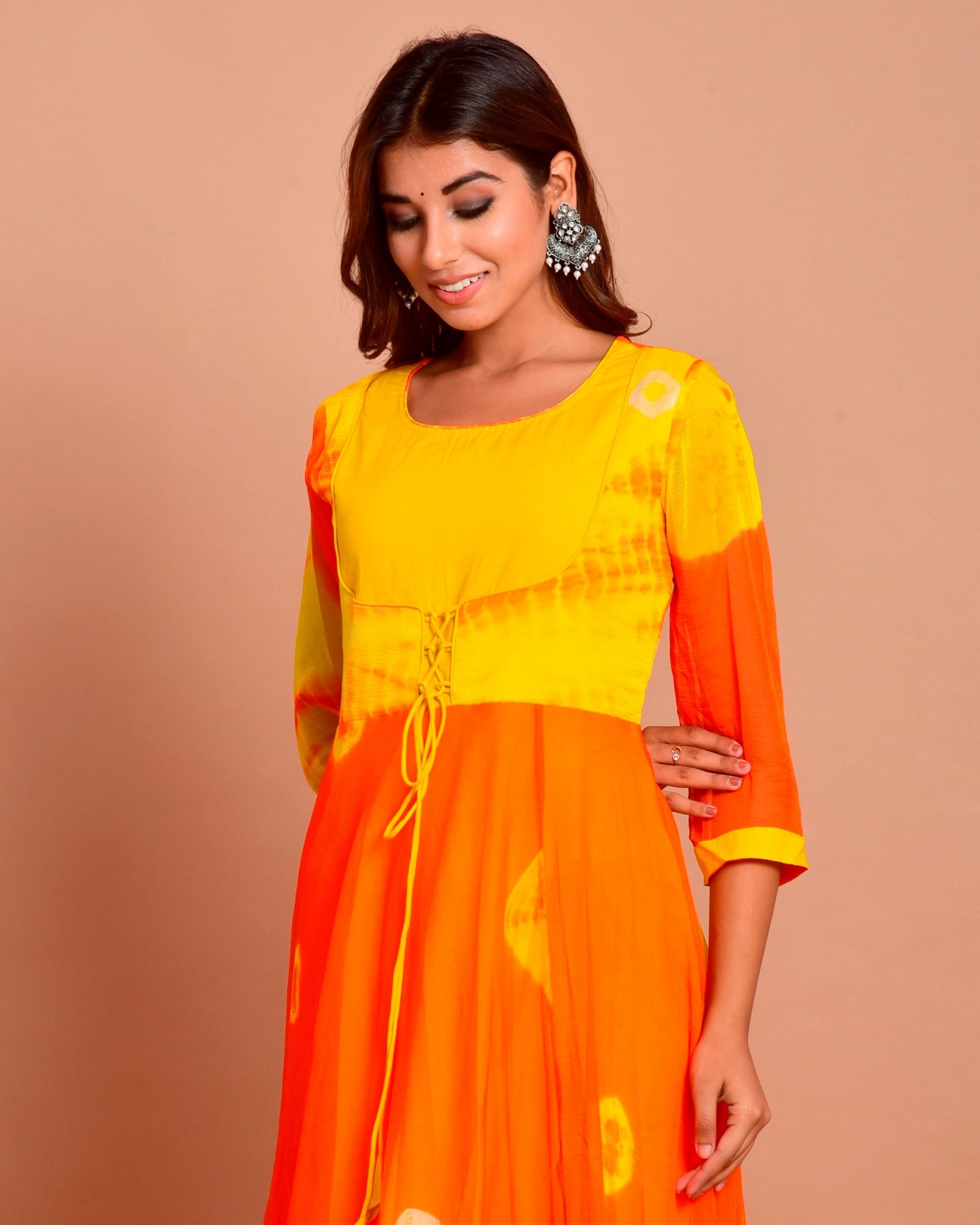 Orange and yellow tie and dye dress with gota work by Chokhi Bandhani