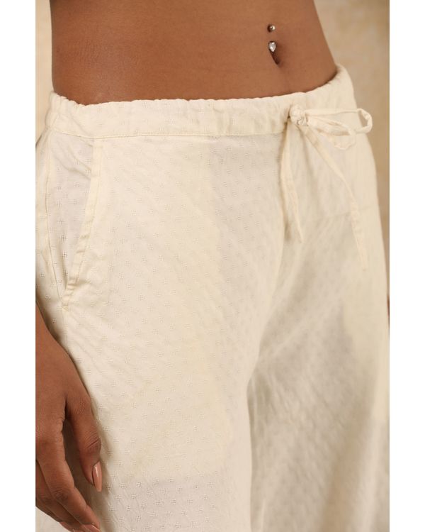 White cotton pants with embroidered detailing at hem 1